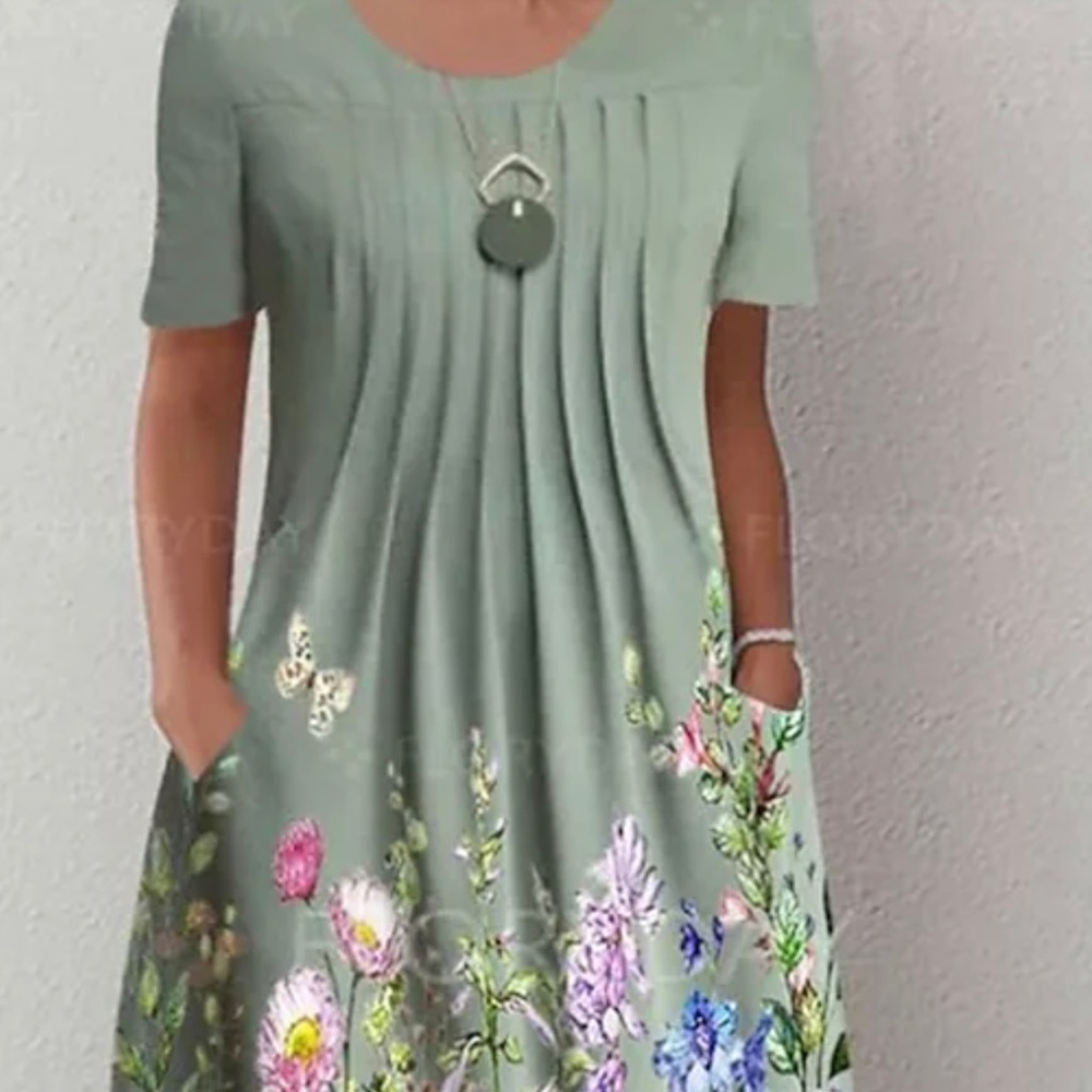 Women’s A-line midi dress is short sleeve floral with pockets.